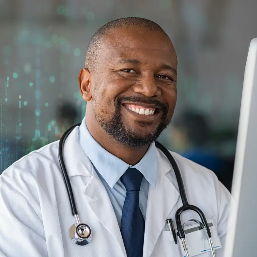 A cheerful male doctor in a white coat, representing care and expertise in a healthcare environment.