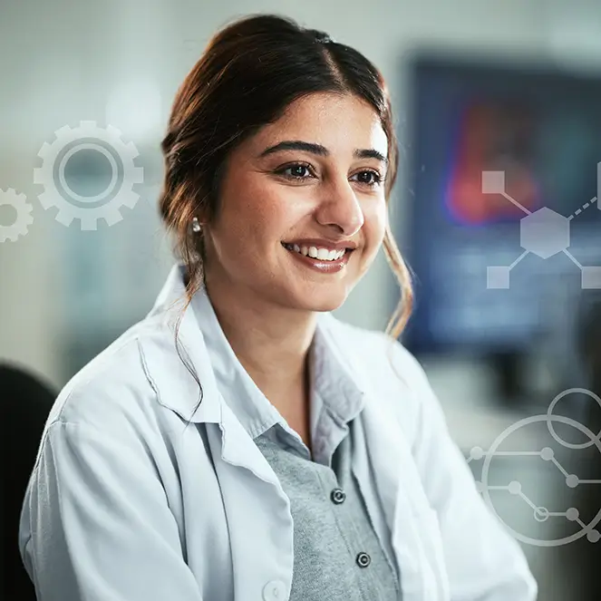 A woman in a lab coat smiles confidently, embodying professionalism and enthusiasm in a laboratory setting.